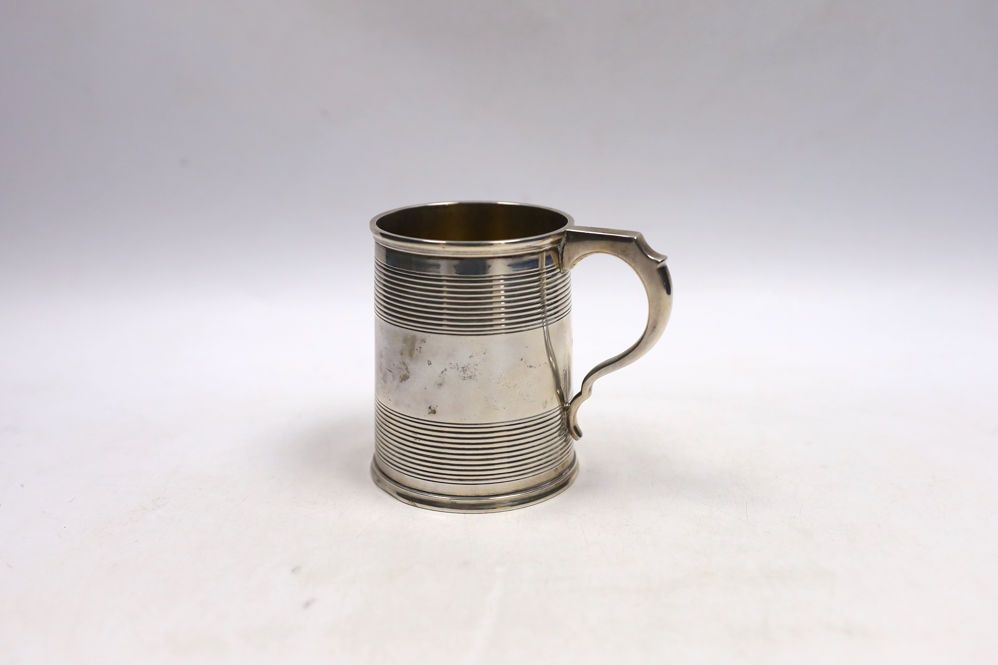 A Victorian reeded silver christening mug, William Evans, London, 1878, 87mm.